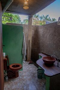 a bathroom with a toilet and a sink at Bangalôs Suítes na Floresta Encantada in Santarém +45 photos