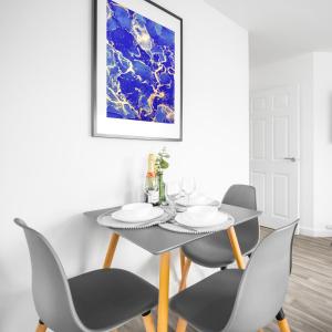 a dining room with a black table and chairs at Modern Two Bed Apartment - Sleeps 3 - WiFi & Parking Included 57C in Sleightholme
