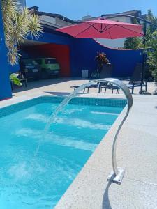 American Hostel e Pousada في جوينفيل: مسبح يخرج منه شطاف