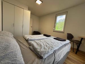 a bedroom with a bed and a window at HAVENU Ludwigsburg Mitte in Ludwigsburg