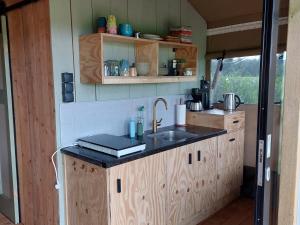 a kitchen with a sink and a counter top at Vakantieboerderij Den Deter in Meddoo