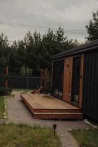 a wooden deck with a bench on top of it at Aframe Shepit in Sosnovka +43 photos