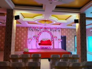 une salle de banquet avec une table et des chaises rouges dans l'établissement Hotel The Siwan International, à Siwān