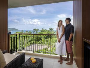 a man and a woman standing on a balcony at Novotel Phuket Kata Avista Resort and Spa in Kata Beach