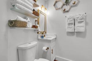 a bathroom with a toilet and a sink and towels at La Barra #101 in St. Pete Beach +40 photos
