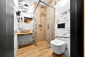 a bathroom with a toilet and a shower at Grand Regle Resort & SPA in Poronin +153 photos