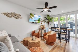 a living room with a couch and a ceiling fan at La Barra #101.5 in St. Pete Beach