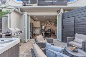 a patio with a couch and chairs and a kitchen at La Barra #101.5 in St. Pete Beach