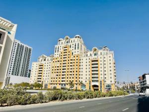a large building on the side of a road at Stylish Furnsihed Apartments Opposite Five Hotel In JVC in Dubai