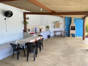 een patio met een tafel en stoelen en een keuken bij Chácara Andorinhas São Pedro SP in São Pedro