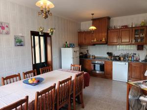 a kitchen with a table with a bowl of fruit on it at Quinta do Olival - Douro Valley in Sande +16 photos