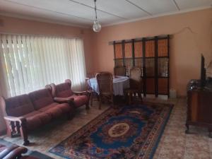 a living room with a couch and a table at Sleep Well in Amanzimtoti