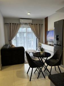 een woonkamer met een tafel en een bank bij The Nook in Gaborone