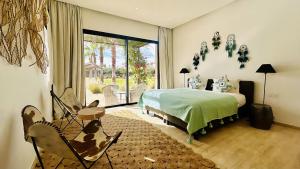 a bedroom with a bed and a large window at Villa Sbaa Marrakech in Marrakesh +68 photos