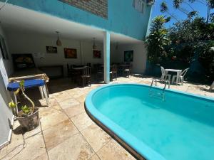 a large blue bath tub sitting next to a patio at Pipa Hotel Pe na Areia in Pipa