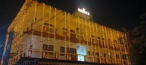 a building with christmas lights on the side of it at Godiva Homestay in Cochin +9 photos