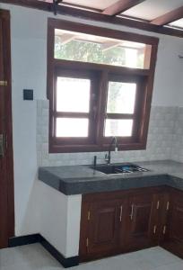 a kitchen with a sink and a window at Sunny's Hide Out in Talalla