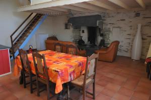 ein Esszimmer mit Tisch und eine Küche in der Unterkunft Gîte Erziwezh in La Porte