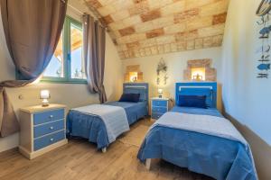 En eller flere senge i et værelse på Villa Renedda