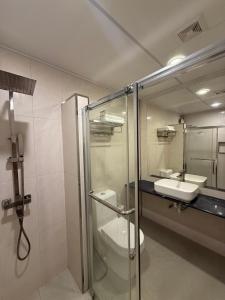 a bathroom with a shower and a toilet and a sink at Old Town Beach in Gaafaru +22 photos