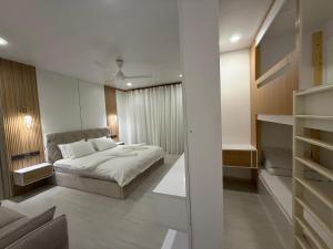 a bedroom with a bed and a room with a closet at Old Town Beach in Gaafaru