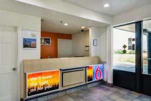a waiting room with a sign in a building at Motel 6-Waukegan, IL in Waukegan
