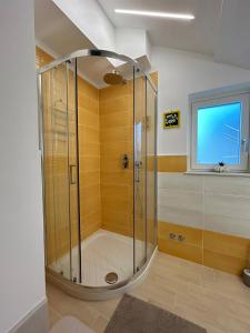 a shower with a glass door in a bathroom at La Dimora del Bacchiss in Amalfi
