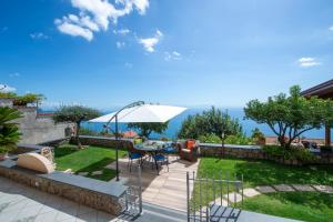 a patio with a table and an umbrella at La Dimora del Bacchiss in Amalfi
