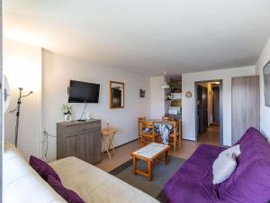 a living room with a couch and a tv at Studio cabine cosy 5 pers, près des pistes, parking inclus - FR-1-404-16 in La Mongie +3 photos