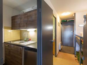 a small kitchen with a sink and a counter top at Studio cabine cosy 5 pers, près des pistes, parking inclus - FR-1-404-16 in La Mongie