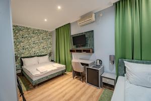 Ένα ή περισσότερα κρεβάτια σε δωμάτιο στο Garni Hotel Mediteraneo