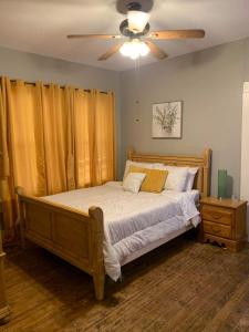 a bedroom with a bed with a ceiling fan at Cozy Home close to Downtown in San Antonio