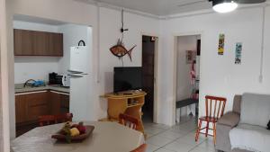 a kitchen and living room with a table and chairs at Casa da Cal in Torres +21 photos