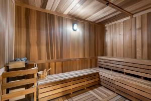 a sauna with wood paneling and a bench in it at Downtown Miami - Rooftop Pool & Gym in Miami