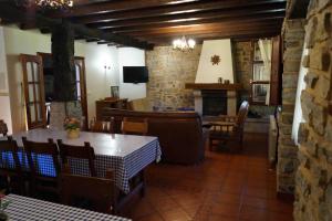 a dining room with a table and a fireplace at Goikoetxe Baserria in Zeanuri