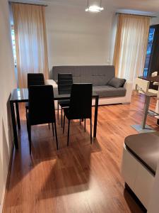 a living room with a table and chairs and a couch at Appartamento Family Park2 in Andalo