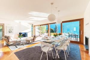 un salon avec une table, des chaises et un canapé dans l'établissement Villa Mara - by MyHomeInComo, à Côme