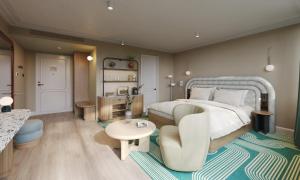 a large bedroom with a bed and a chair at Hotel Indigo London K West Shepherd's Bush by IHG in London