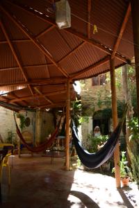 deux hamacs suspendus sous un toit dans une terrasse dans l'établissement El Garaje Hostal, à Taganga