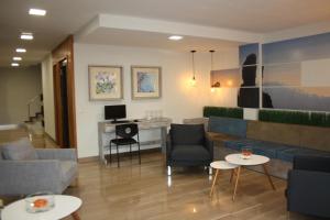 a living room with a couch and a desk at ApartHotel Idafe in Las Palmas de Gran Canaria