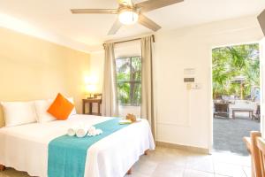 a bedroom with a bed with a blue blanket at La Diosa Kali Beach Front Hotel in Holbox Island