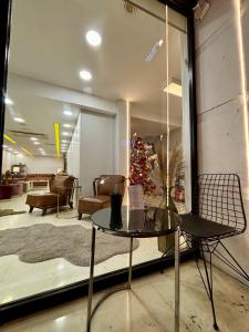 a room with a table and a christmas tree in a store at Wame Suite Hotel Nisantasi in Istanbul