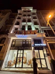 a white building with a sign on the front of it at Wame Suite Hotel Nisantasi in Istanbul