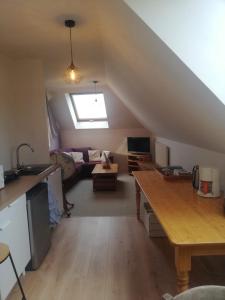 a kitchen and living room with a loft at la maison de la Felicidad in Boussy
