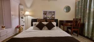 a bedroom with a bed and a desk and a table at The Moonvale Cottage A Victorian Theme Independent Homestay! in Chandīgarh