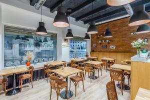 a dining room with tables and chairs in a restaurant at Downtown Bratislava B&B in Bratislava