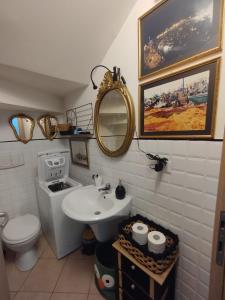 a bathroom with a sink and a toilet and a mirror at Alice in Wonderland in Sutri