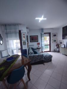 a living room with a table and a couch at Alice in Wonderland in Sutri