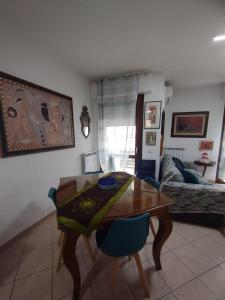 a living room with a table and a couch at Alice in Wonderland in Sutri