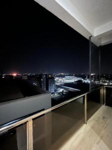 a room with a view of a city at night at Apex apartment in Ilado